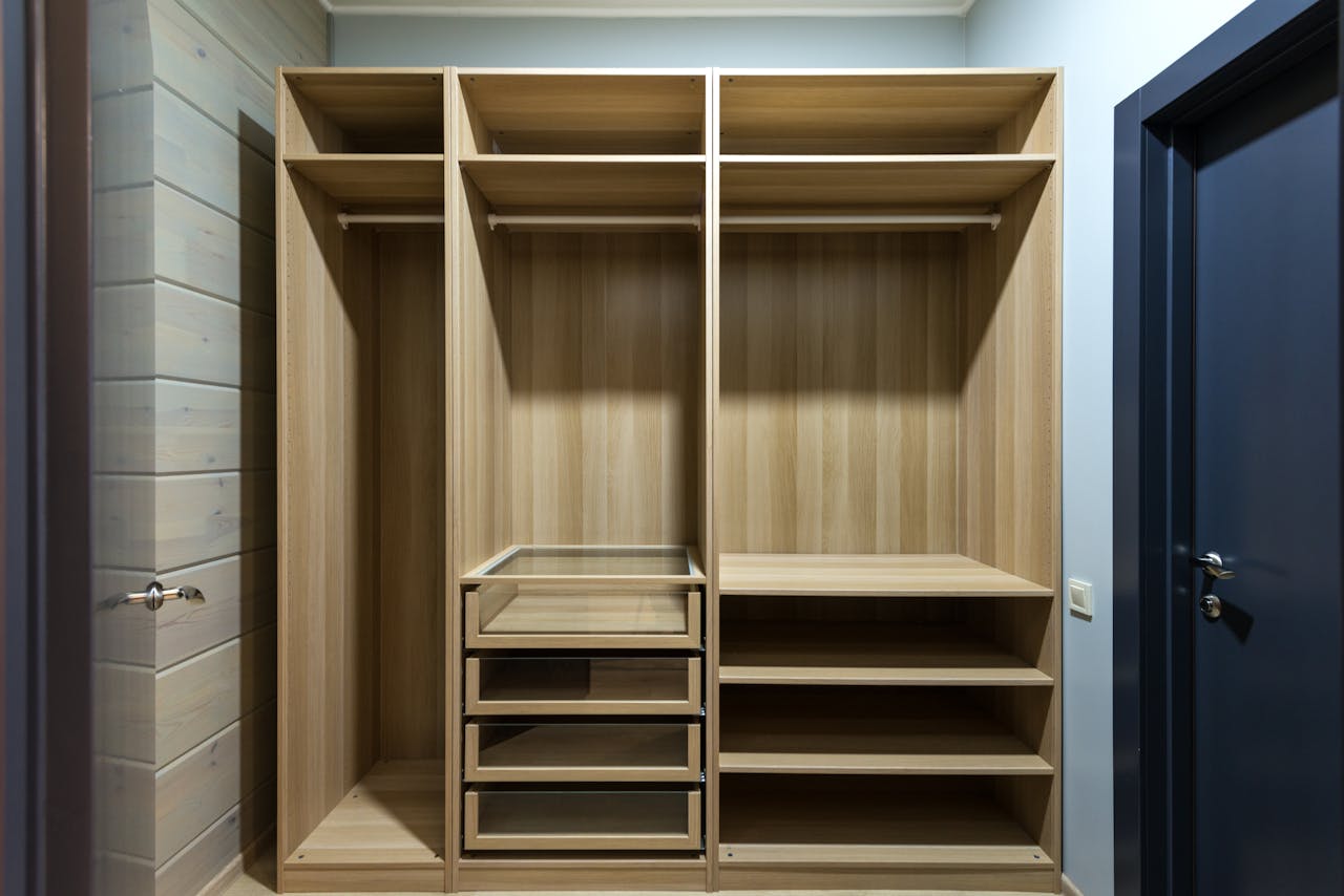 Contemporary wooden wardrobe with shelves and drawers, ideal for minimalist interior design.